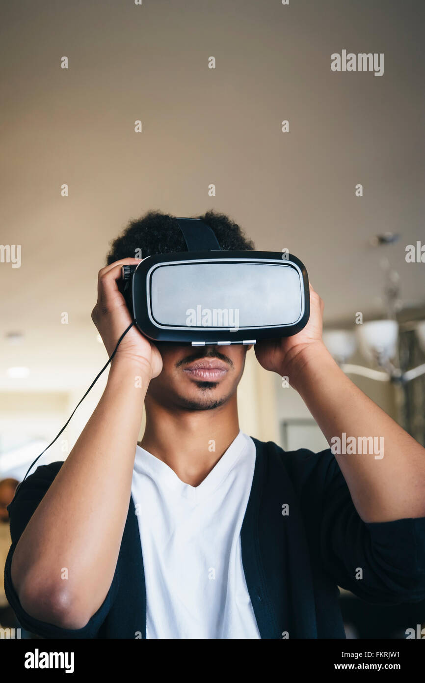 Mixed Race man en utilisant des lunettes de réalité virtuelle Banque D'Images
