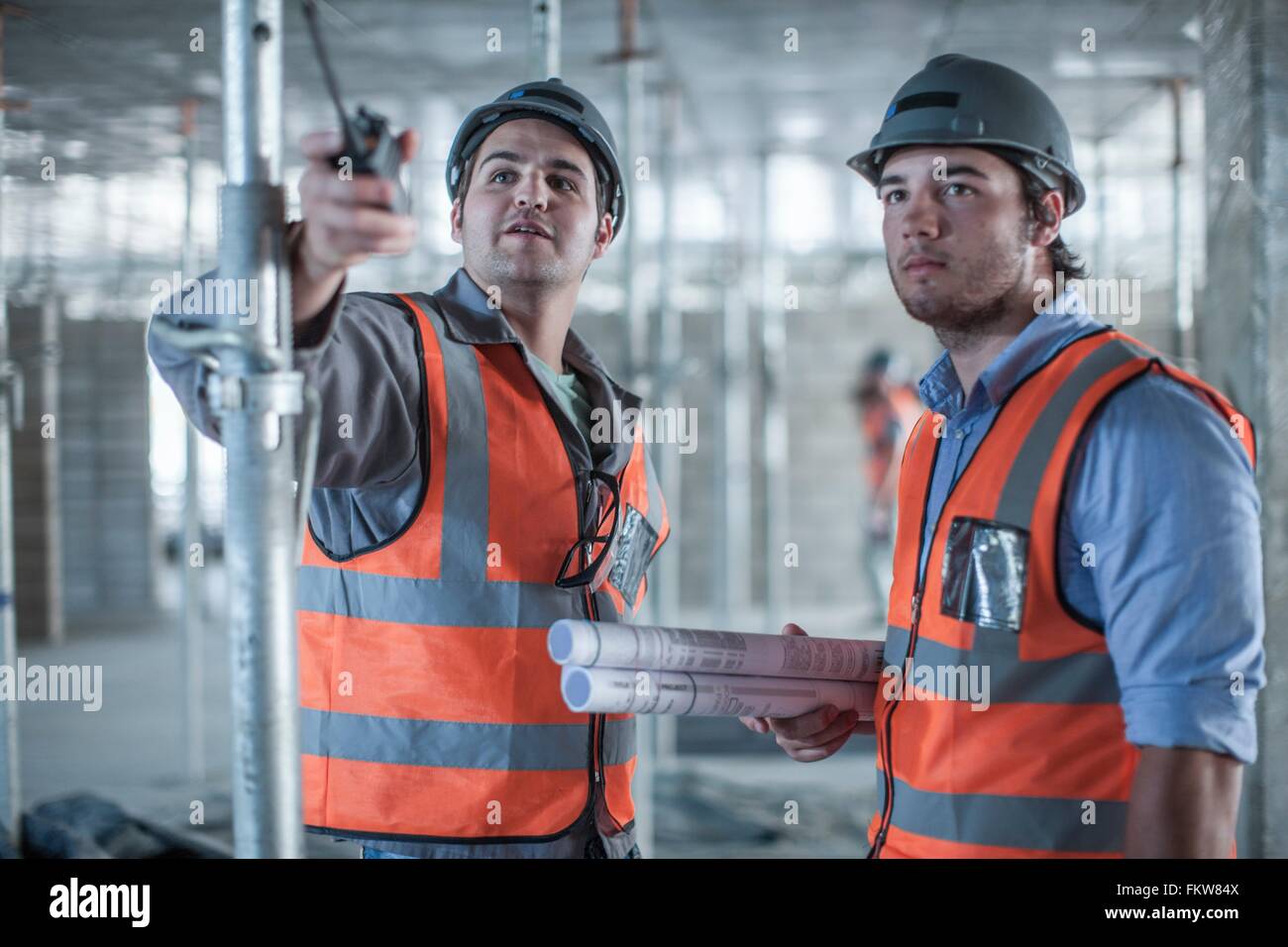 Site manager et builder pointant on construction site Banque D'Images