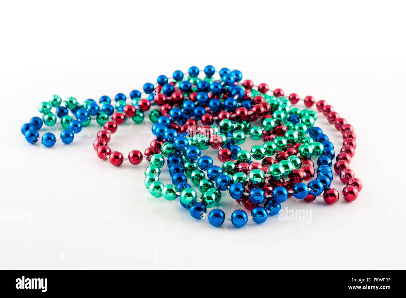 Perles Mardi Gras avec différentes couleurs : rouge, vert et bleu isolé sur fond blanc Banque D'Images