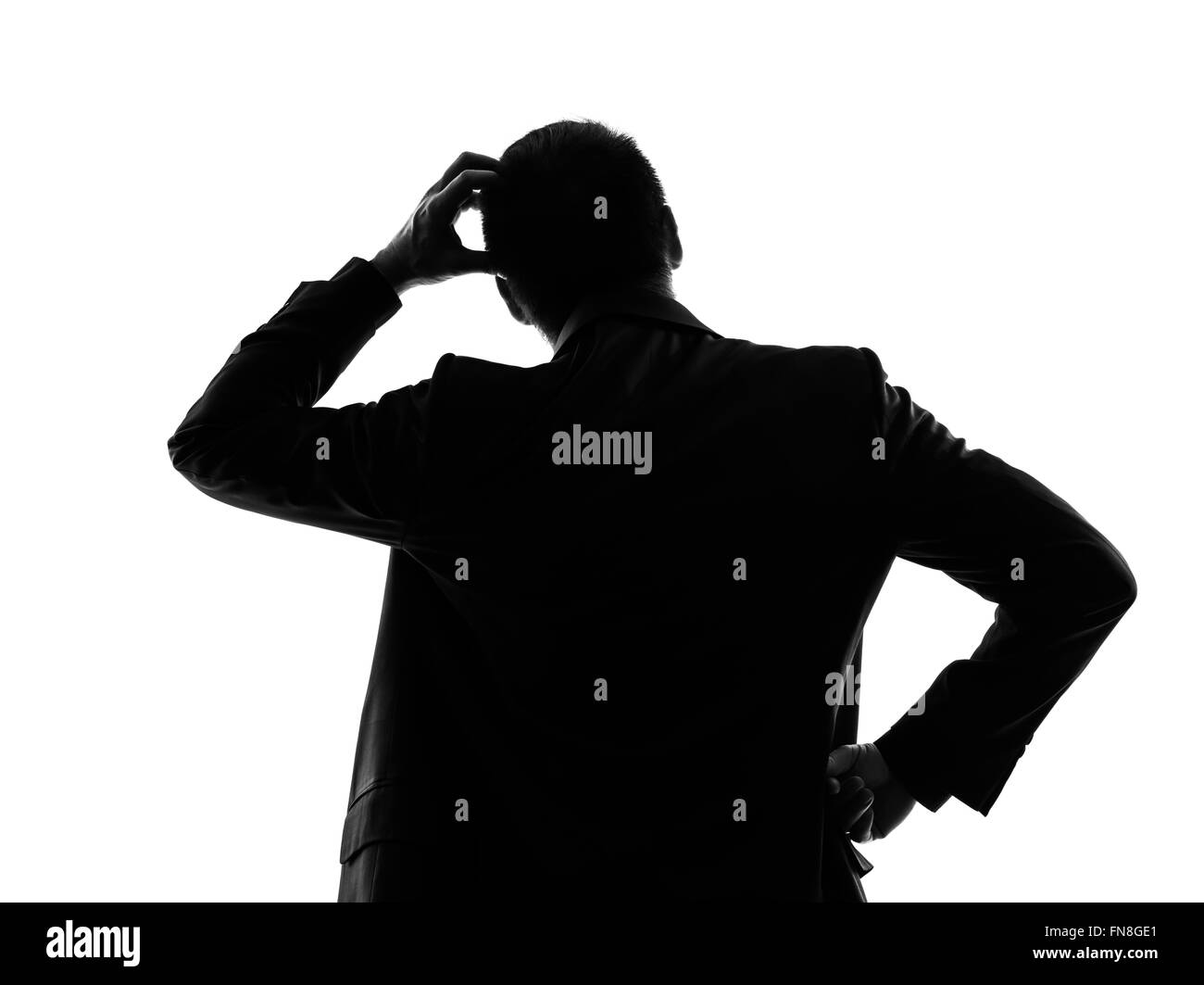 Un caucasian business man thinking vue arrière retour en silhouette sur fond blanc Banque D'Images