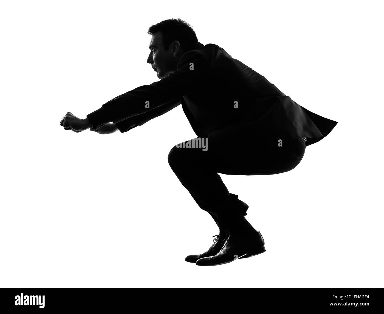 Un caucasian business man driving moto imaginaire en silhouette sur fond blanc Banque D'Images