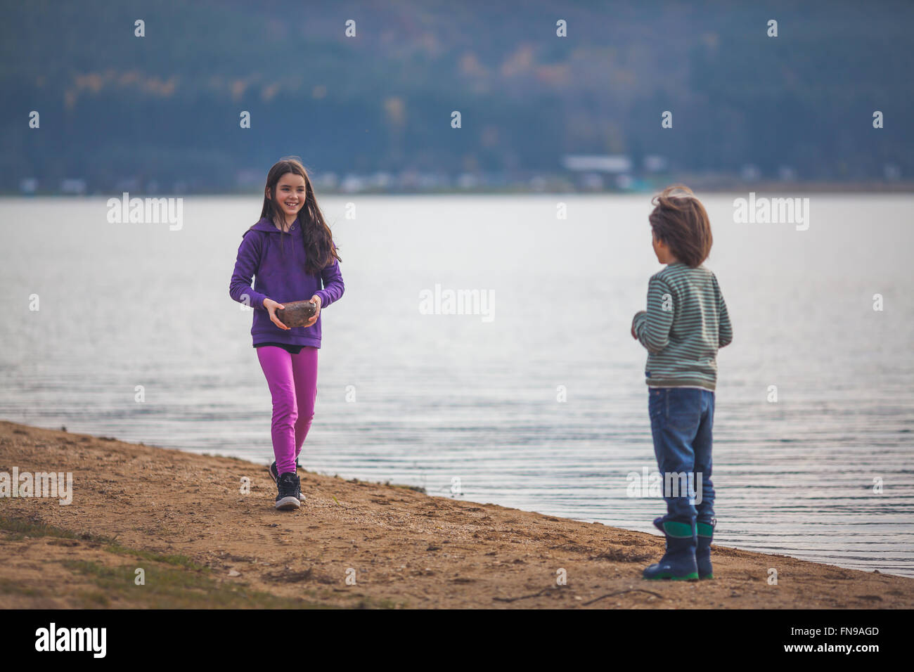 Garçon et fille par un lac Banque D'Images