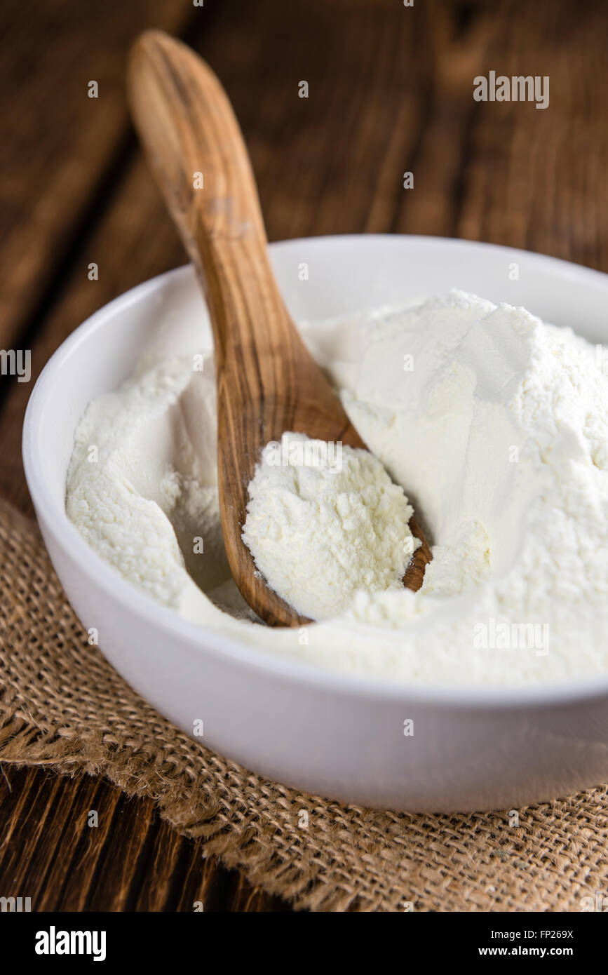 Partie de lait en poudre (selective focus) sur une vieille table en bois Banque D'Images