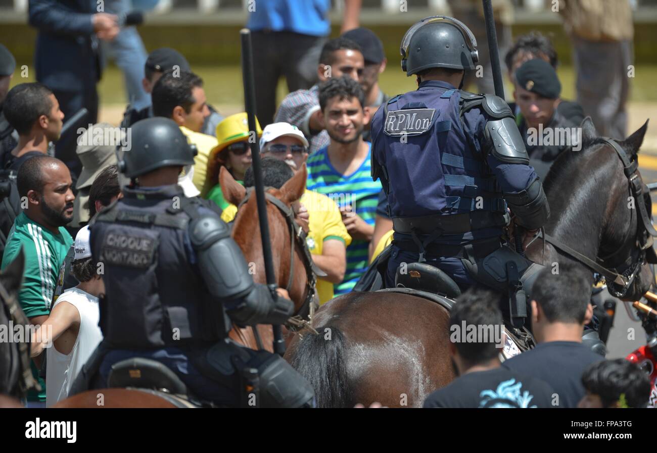 Des milliers de manifestants anti-gouvernement se faire prendre par la police anti-émeute qui se rassemble à l'extérieur du palais présidentiel du Planalto, 17 mars 2016 à Brasilia, Brésil. L'ancien Président Lula da Silva a été assermenté comme Chef du personnel dans une tentative pour éviter les poursuites dans une importante affaire de corruption. Banque D'Images