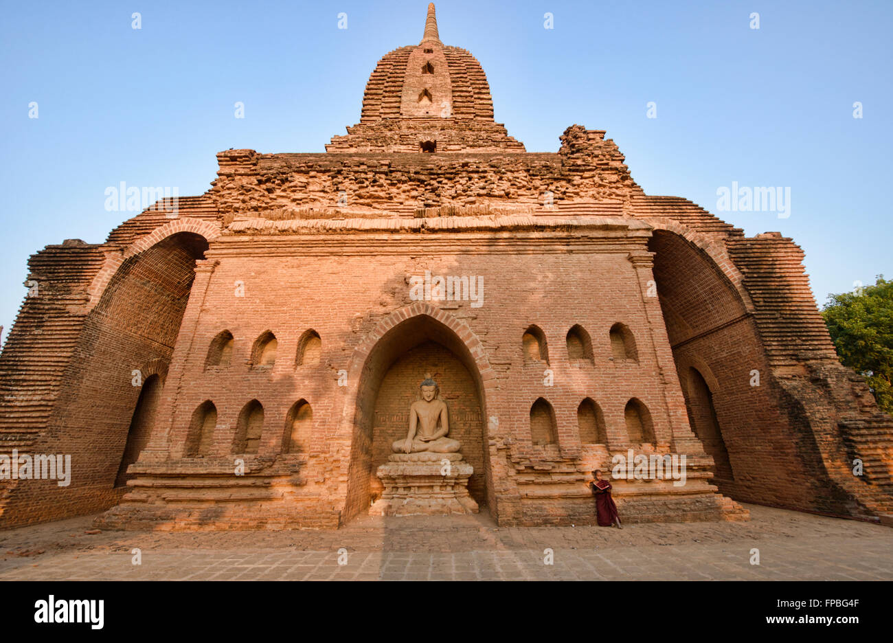 Un jeune moine lecture dans les temples de Bagan, Myanmar Banque D'Images