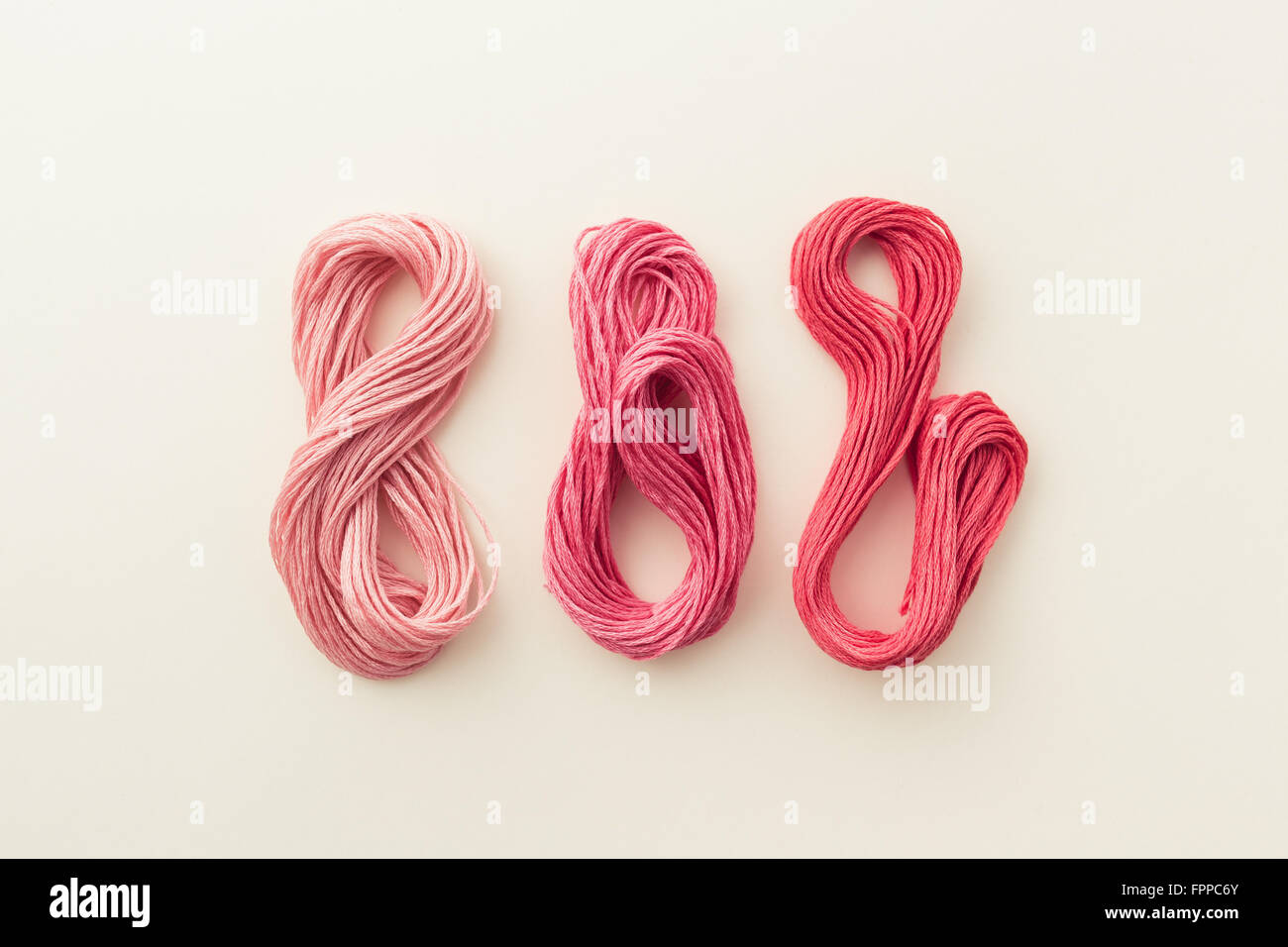Fils de couture dans ton rose. Banque D'Images