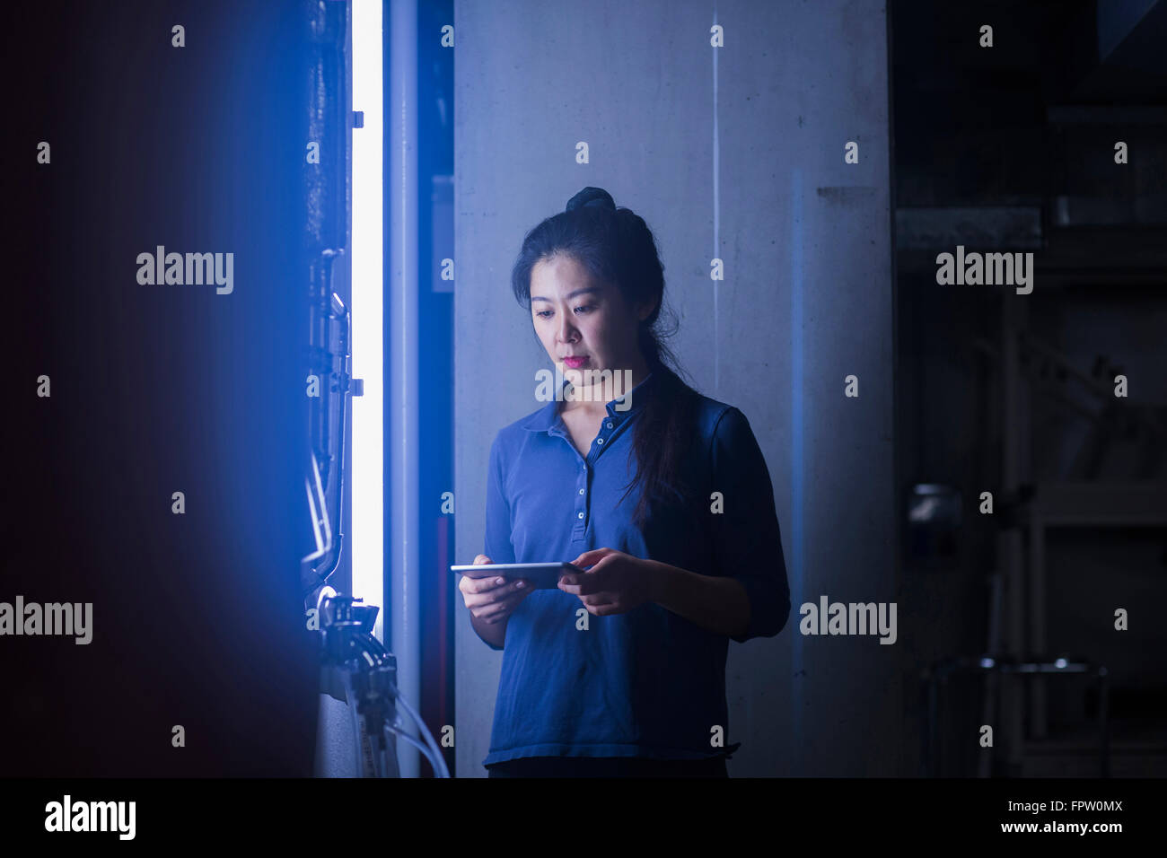 Jeune femme de l'ingénieur dans une usine industrielle, Freiburg im Breisgau, Bade-Wurtemberg, Allemagne Banque D'Images