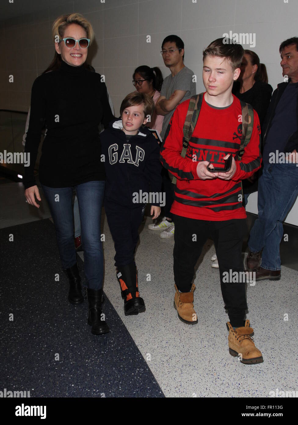 Sharon Stone arrive sur un vol vers l'Aéroport International de Los Angeles (LAX) avec ses fils avec : Sharon Stone, Roan Joseph Bronstein, Quinn Kelly Stone, Laird Vonne Stone Où : Los Angeles, California, United States Quand : 18 févr. 2016 Banque D'Images