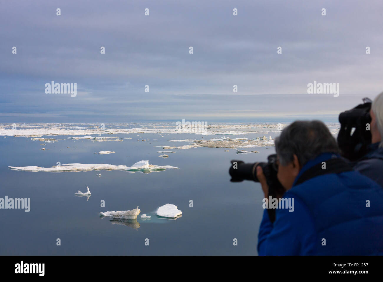 Tourist photographing glace flottante en mer de Tchoukotka, en Russie extrême-orient Banque D'Images