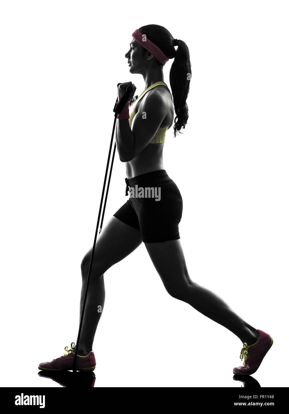 Une femme l'exercice de fitness workout bandes de résistance en silhouette sur fond blanc Banque D'Images