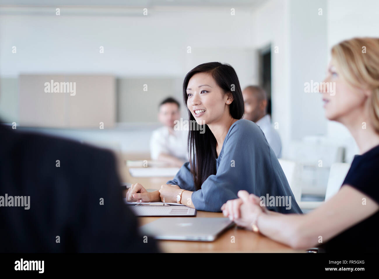 Smiling businesswoman in meeting Banque D'Images