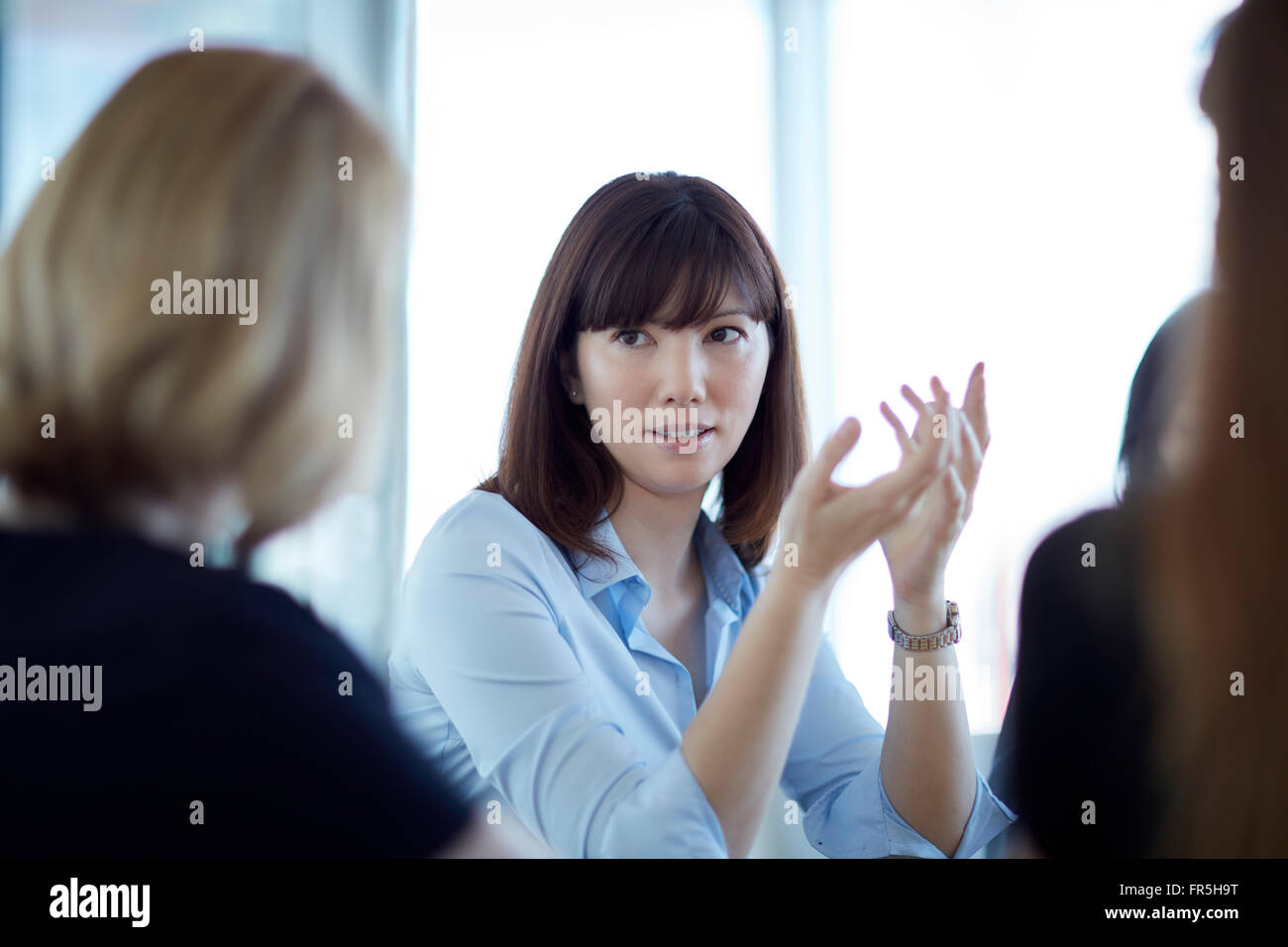 Businesswoman gesturing et talking in meeting Banque D'Images