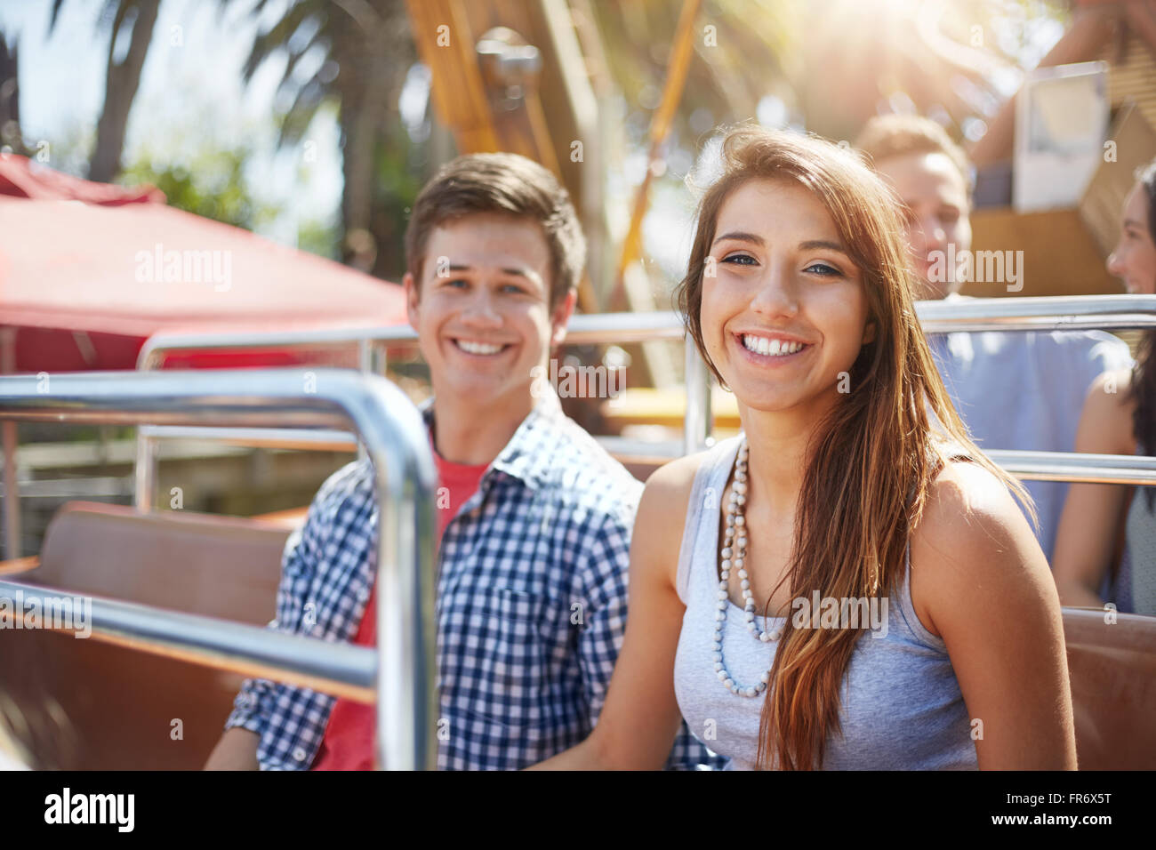 Portrait of smiling young couple on amusement park ride Banque D'Images