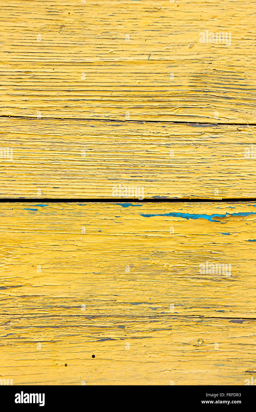 Texture bois avec peinture la couleur est arrachée. Peinture jaune écaillée - texture de fond en bois. Banque D'Images