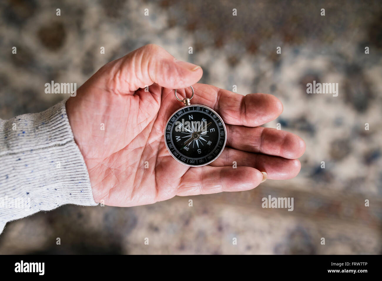 Hand of senior man holding compass, close-up Banque D'Images