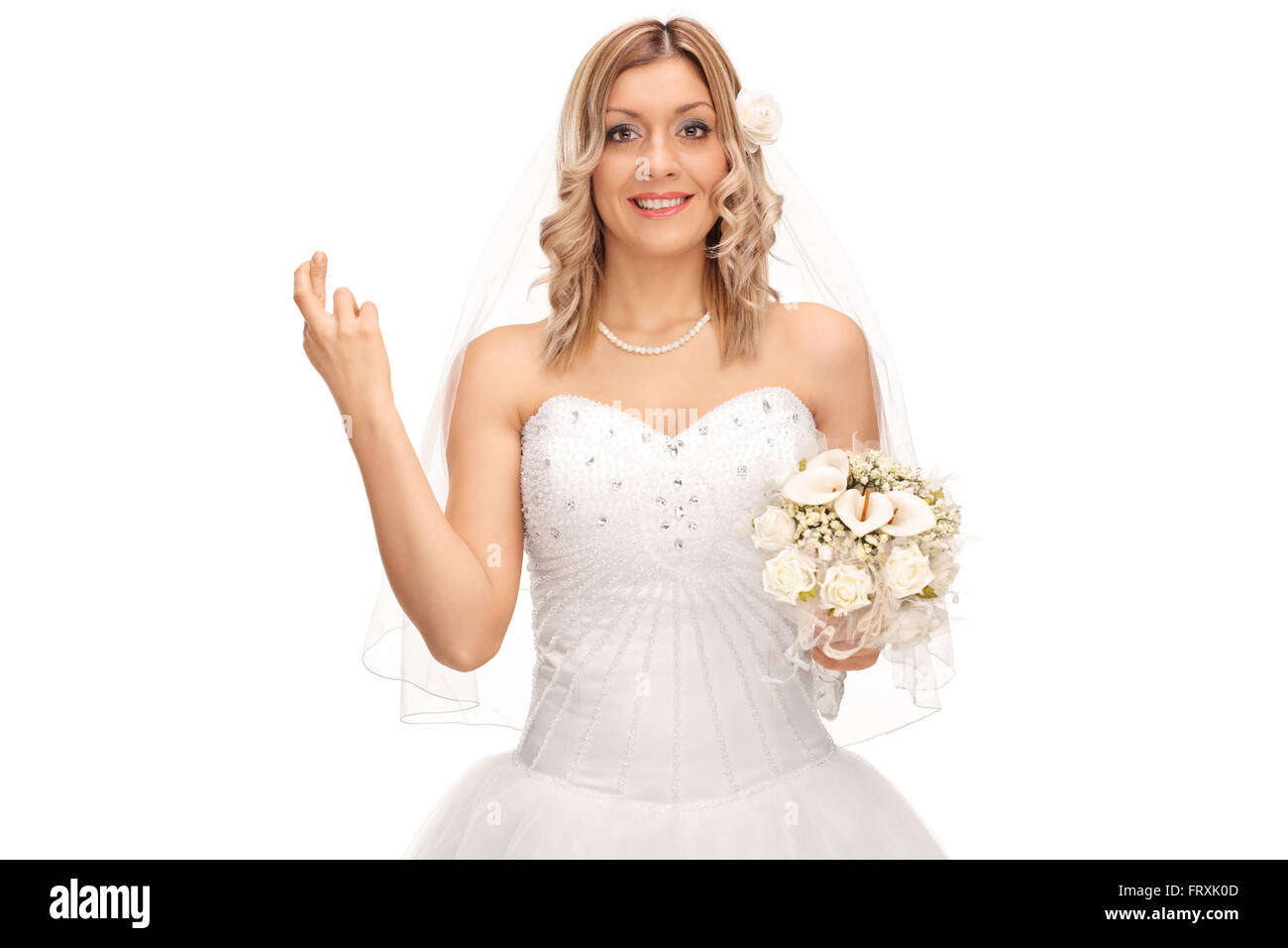 Young Woman smiling et désireux de chance avec ses doigts croisés isolé sur fond blanc Banque D'Images