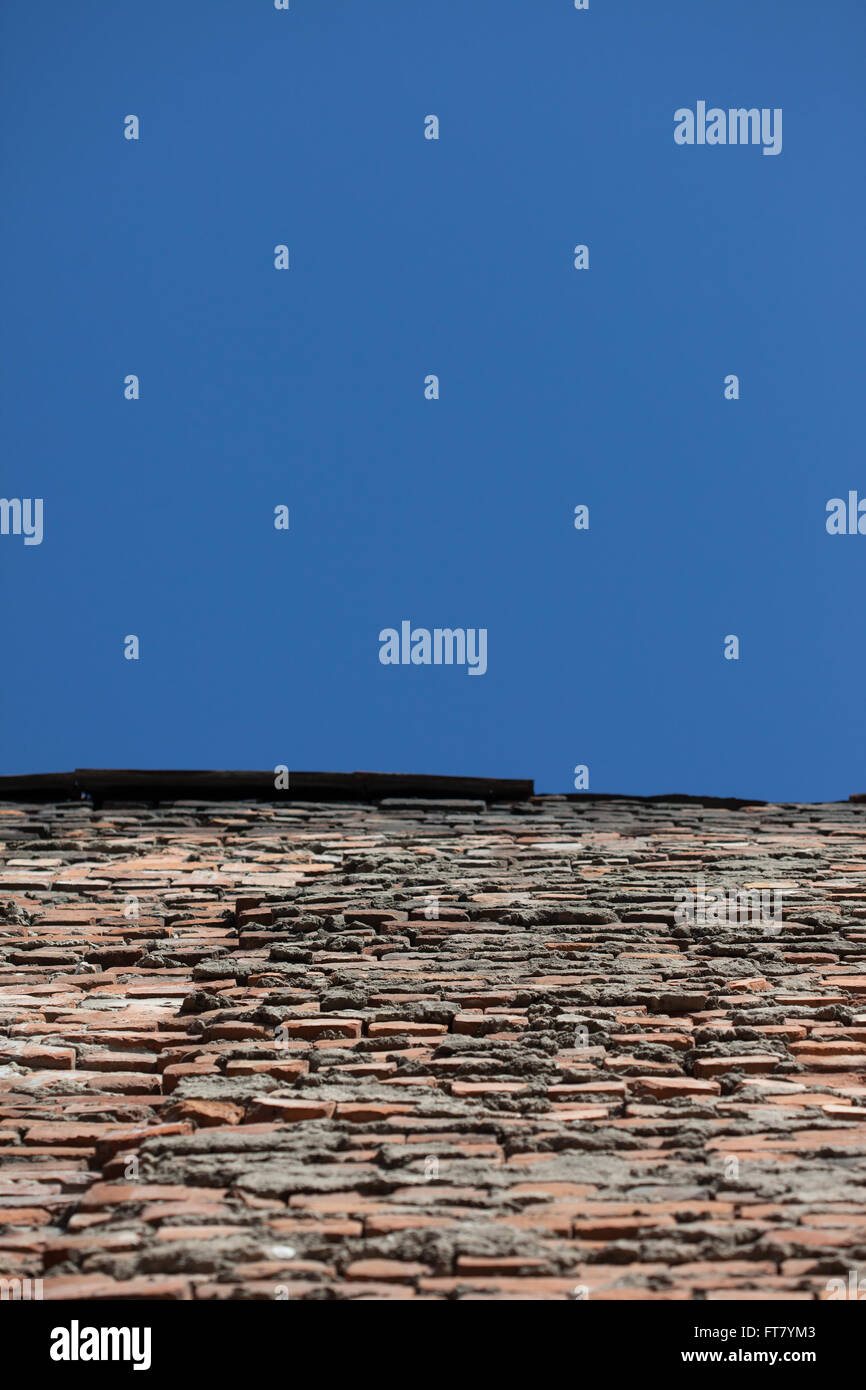 Perspective de l'ancien mur de brique rouge et bleu ciel Banque D'Images