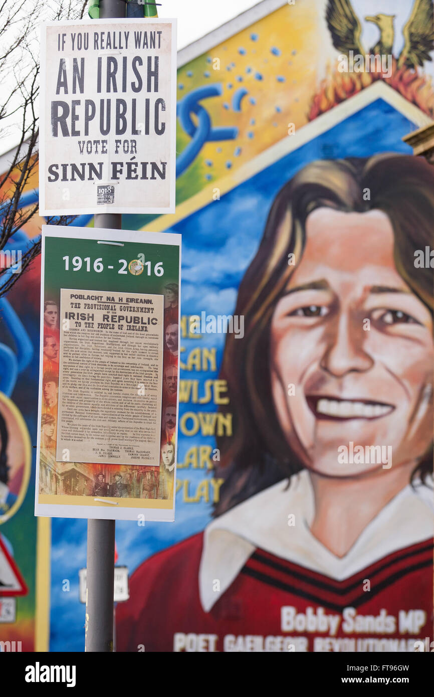 L'Ouest de Belfast, en Irlande. 25 mars, 2016. Le Sinn Fein affiches avec la proclamation de l'Irlande attaché à un lampadaire dans l'Ouest de Belfast. d'une murale de Bobby Sands dans le fond c'est en préparation de la commémoration du 100e anniversaire de l'Insurrection de Pâques Crédit : Bonzo/Alamy Live News Banque D'Images