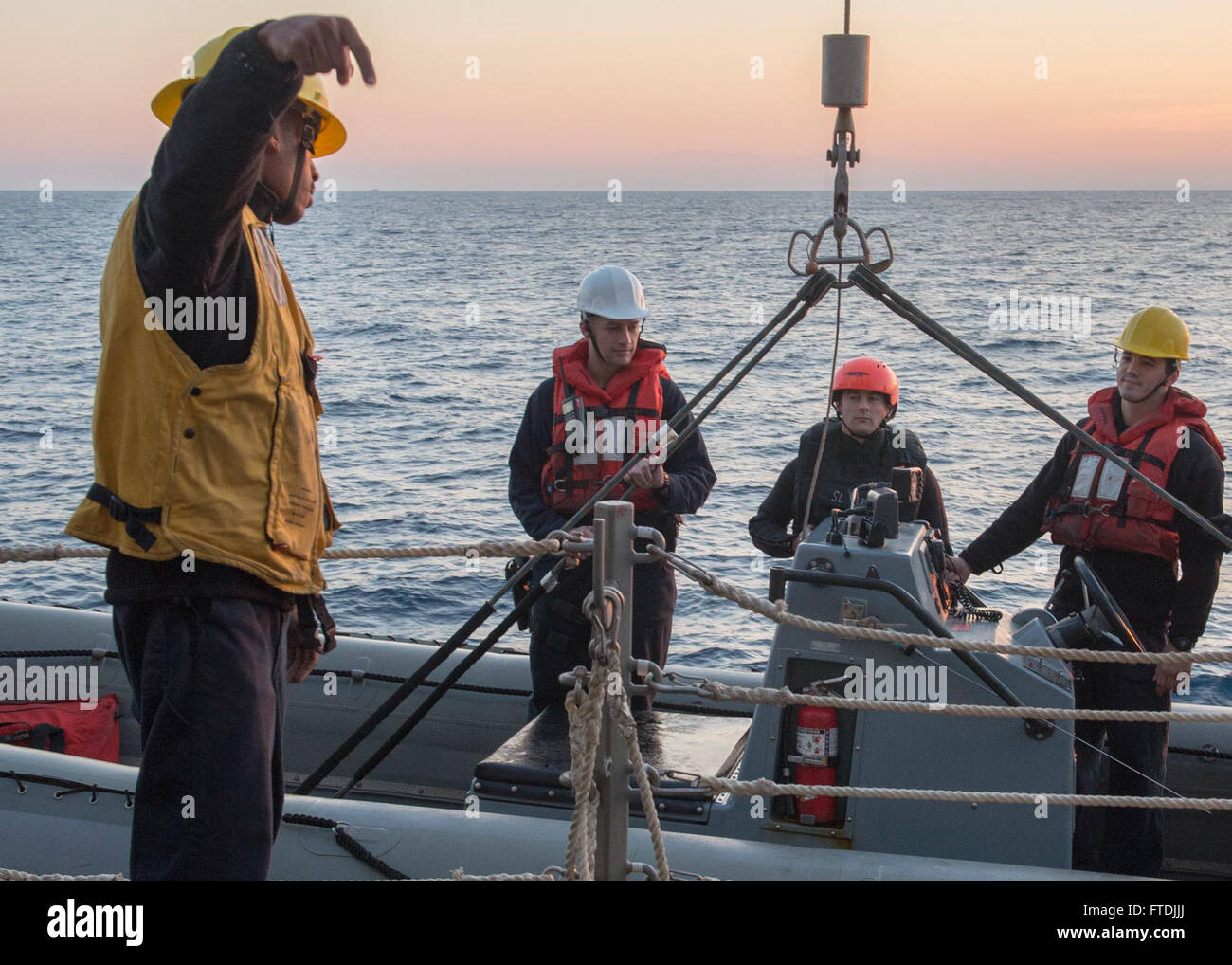 Le 8 décembre 2015, les marins à bord de l'USS Bulkeley (DDG 84) effectuent des opérations de routine en abaissant un bateau gonflable à coque rigide du pont. L'USS Bulkeley, un destroyer à missiles guidés, est déployé en mer Méditerranée dans le cadre des opérations de la marine américaine soutenant les intérêts de sécurité nationale en Europe et en Afrique. Banque D'Images