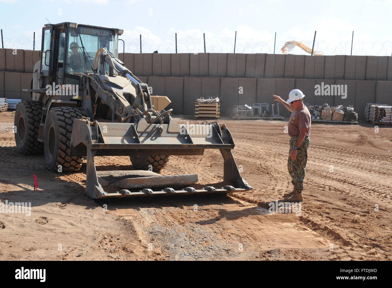 Chris Bidwell, opérateur en chef de l'équipement, dirige Conner Vaughan, opérateur d'équipement de 3e classe, sur un projet d'agrandissement de l'aire de piste à Chebelley, Djibouti. Les opérations de la 6e flotte américaine soutiennent les efforts de sécurité nationale et de stabilité en Europe et en Afrique. Banque D'Images