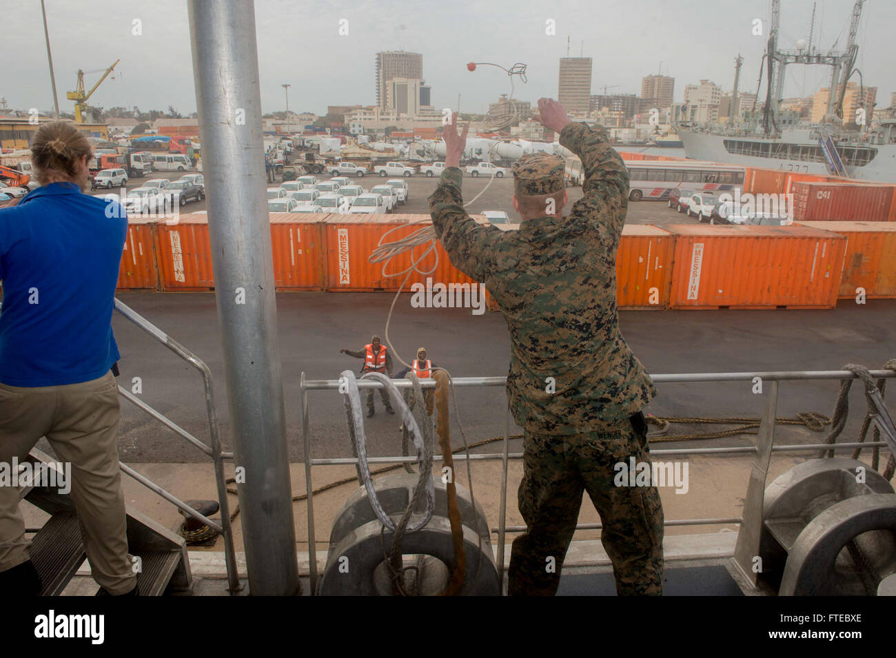 Un Marine américain affecté à la Special Marine Air-Ground Task Force Africa 14 (SPMAGTF-AF14) lance une ligne de messager sur le quai alors que l'USNS Spearhead arrive à Dakar, au Sénégal, pour une visite prévue au port. Cette visite s’inscrit dans le cadre des efforts de sécurité et de renforcement des capacités de la Station africaine du Partenariat dans la zone de la 6e flotte américaine. Banque D'Images