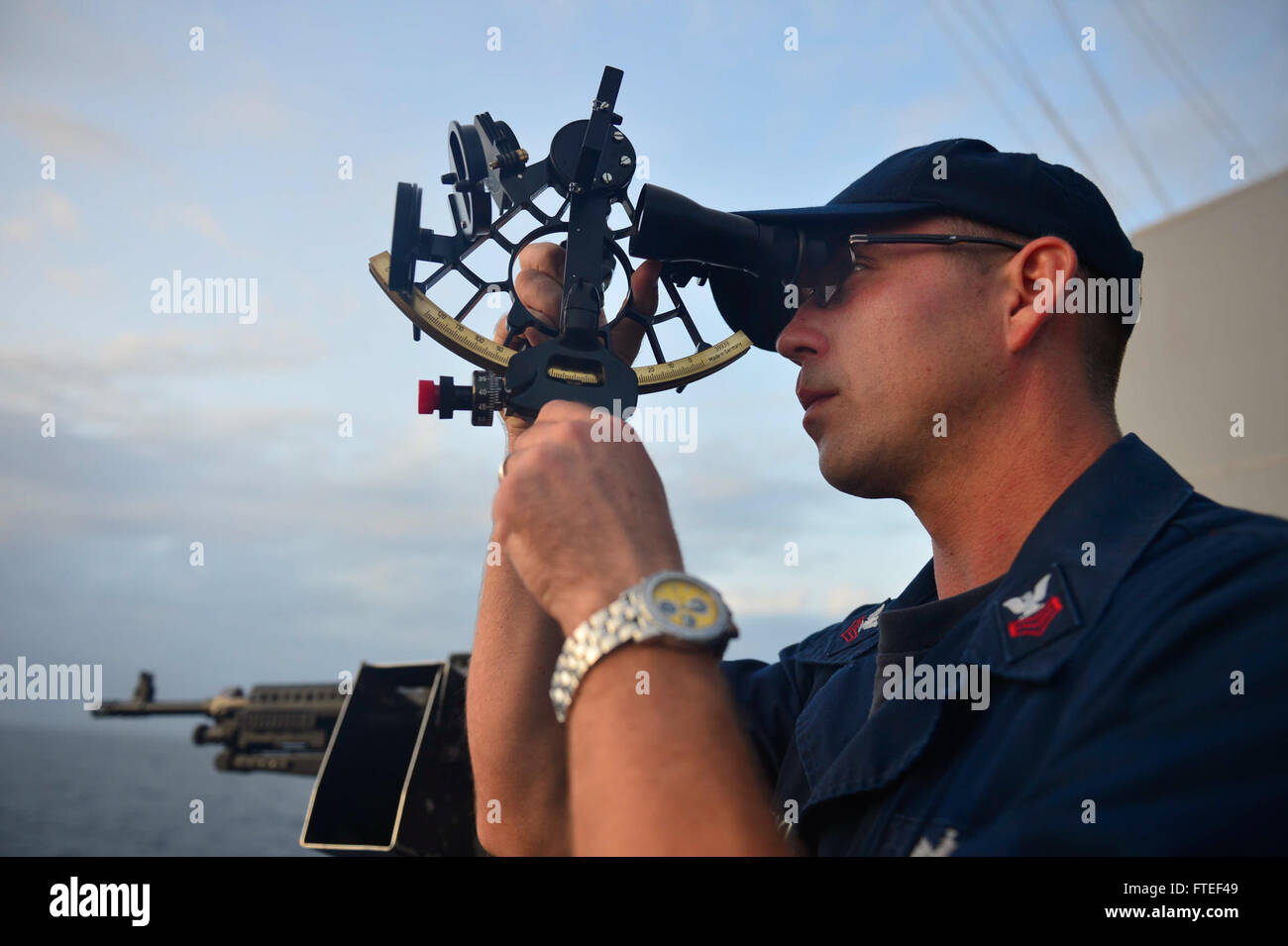 Quarter Master 1st Class Shawn à bord de l'USS Nitze prend des mesures célestes à l'aide d'un sextant lors d'opérations navales dans l'océan Indien. L'USS Nitze soutient les intérêts de sécurité nationale des États-Unis en Afrique dans le cadre des opérations de la 6e flotte américaine. Banque D'Images