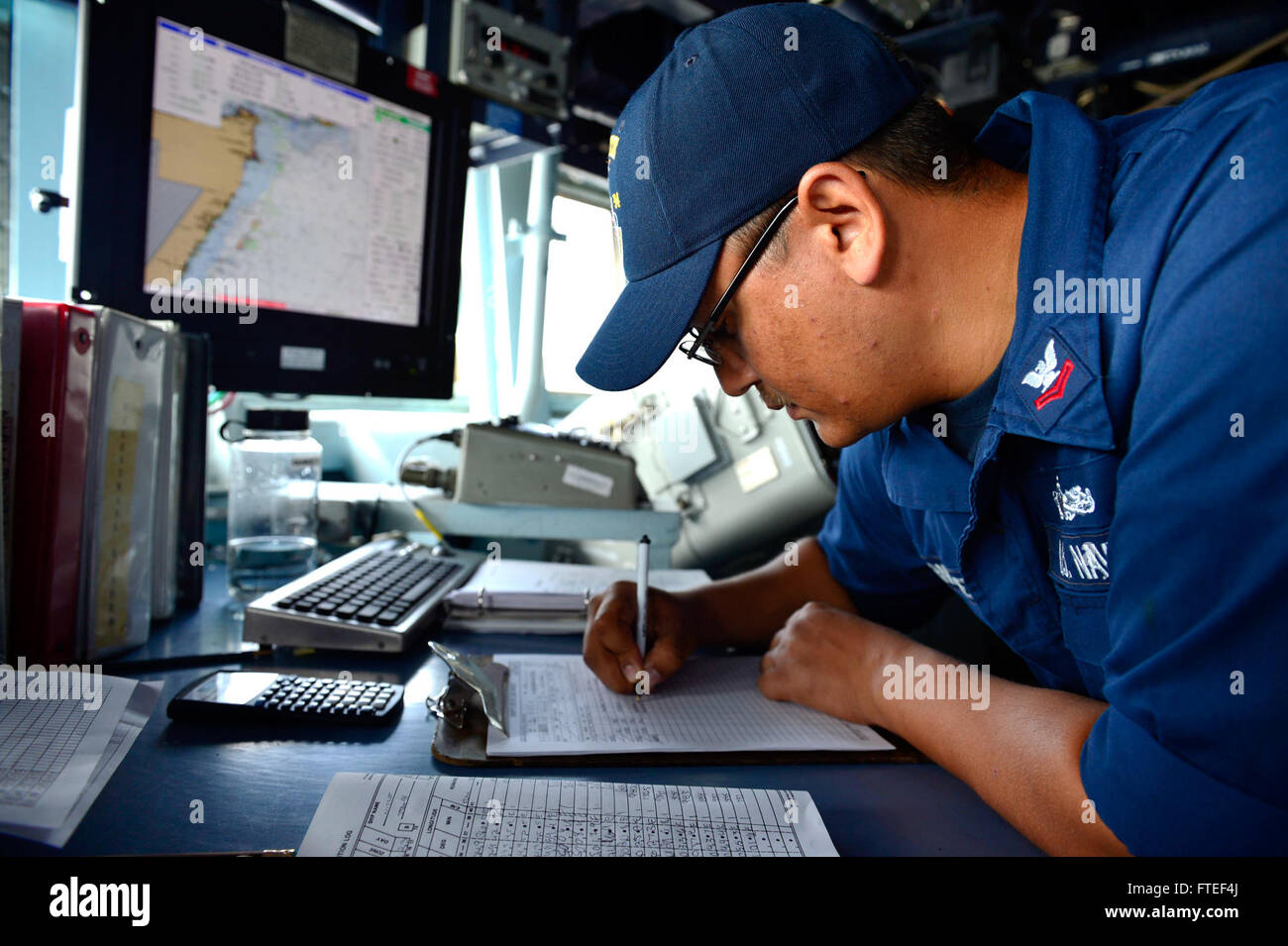 140623-N-AT101-003 : OCÉAN INDIEN (23 juin 2014) - 2e classe Quartier-maître Pedro Hernandez, affectés à l'USS destroyer lance-missiles Nitze (DDG 94), tandis que les données de navigation des journaux le quart sur le pont. Nitze, homeported à Norfolk, Va., mène des opérations navales dans la sixième flotte américaine zone d'opérations à l'appui de la sécurité nationale des États-Unis en Afrique. (U.S. Photo par marine Spécialiste de la communication de masse/Angebrand Maddelin 1ère classe) de parution Banque D'Images