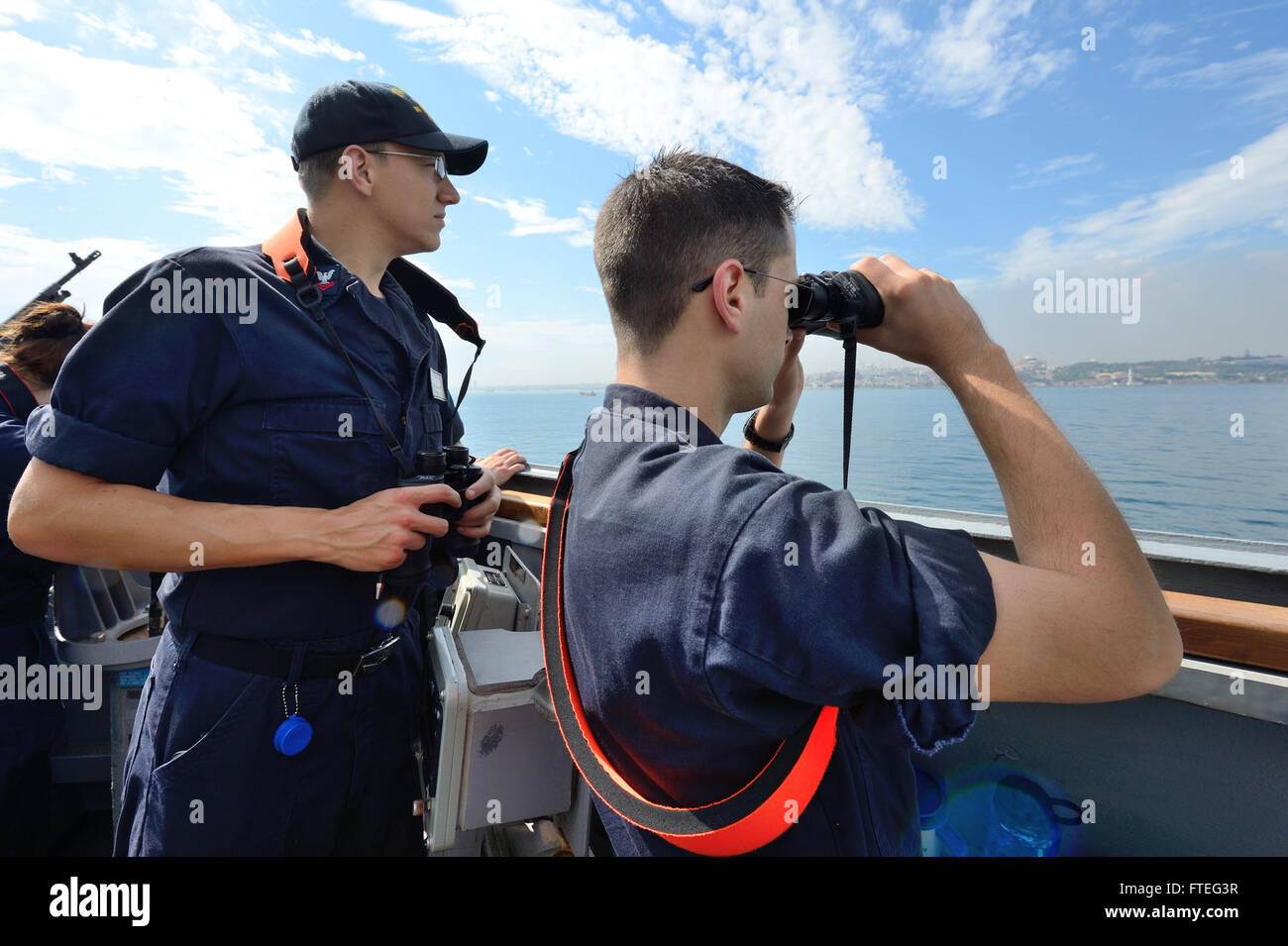 L'enseigne Shea Miller et le Yeoman 2e classe Eric Pfannstiel observent le trafic marchand à bord de l'USS Ross dans le détroit du Bosphore. Ce destroyer à missiles guidés mène des opérations dans la zone de responsabilité de la 6e flotte américaine pour soutenir les intérêts de sécurité nationale en Europe. Banque D'Images