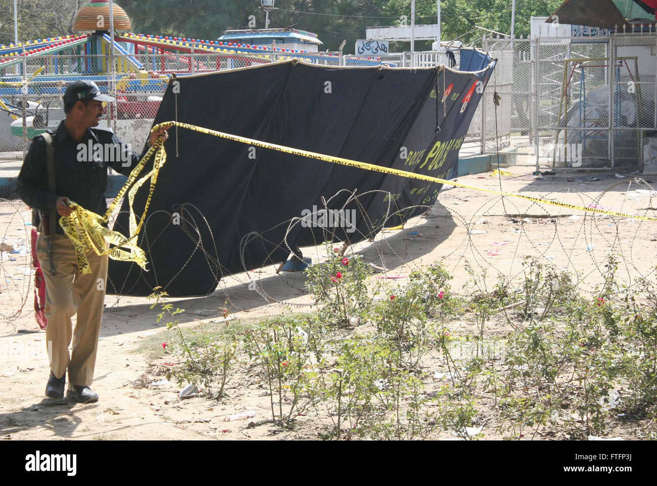 Le personnel de sécurité de boucler sur le lieu deuxième jour de l'explosion suicidaire dans un parc situé à Gulshan-e-Iqbal domaine de Lahore, pour des enquêtes médico-légales le lundi 28 mars 2016. Au moins 72 personnes ont été tuées et plus de 233 blessés lorsqu'une bombe a soufflé sur le parking d'un parc bondé à Lahore où les chrétiens fêtaient le dimanche de Pâques. Banque D'Images