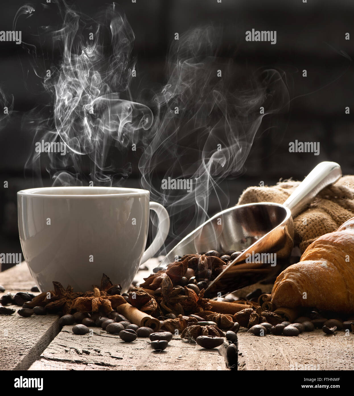 Café chaud et un croissant sur la vieille table en bois Banque D'Images