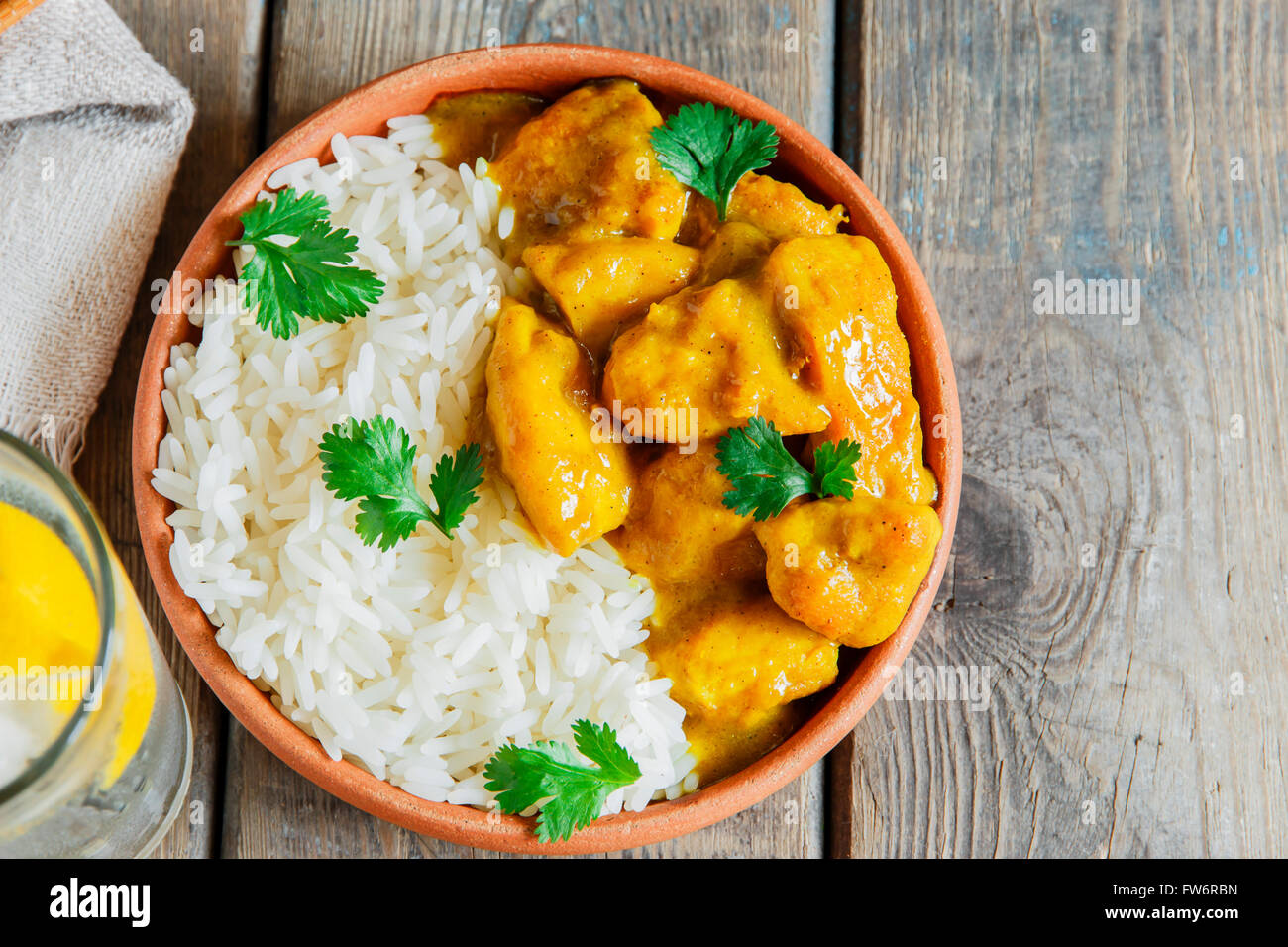 Poulet au curry avec du riz sur une surface en bois Banque D'Images