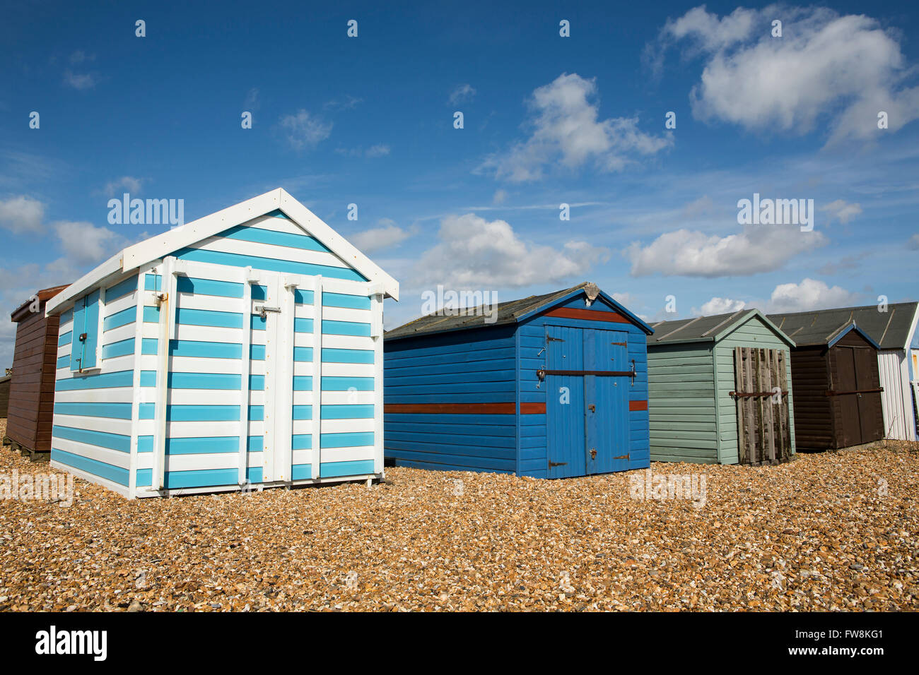 Rangée de cabines colorées sur le front de mer à Hayling Island. Belle journée avec un ciel bleu et nuages moelleux Banque D'Images