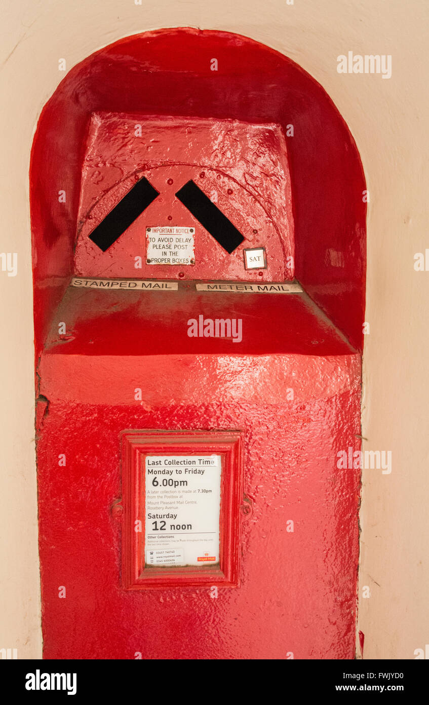 Post box rouge inhabituelle dans le mur de St Barts Hospital, London, England, UK, Banque D'Images