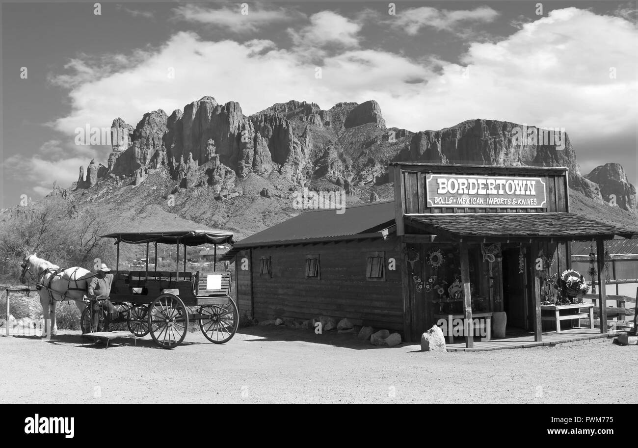 Noir et blanc vieux cowboy du Wild West Town avec calèche et montagnes en arrière-plan Banque D'Images