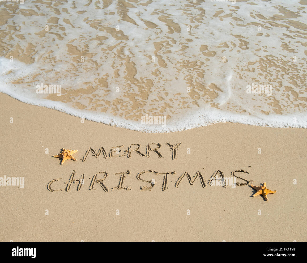 Joyeux Noël written on tropical beach Banque D'Images