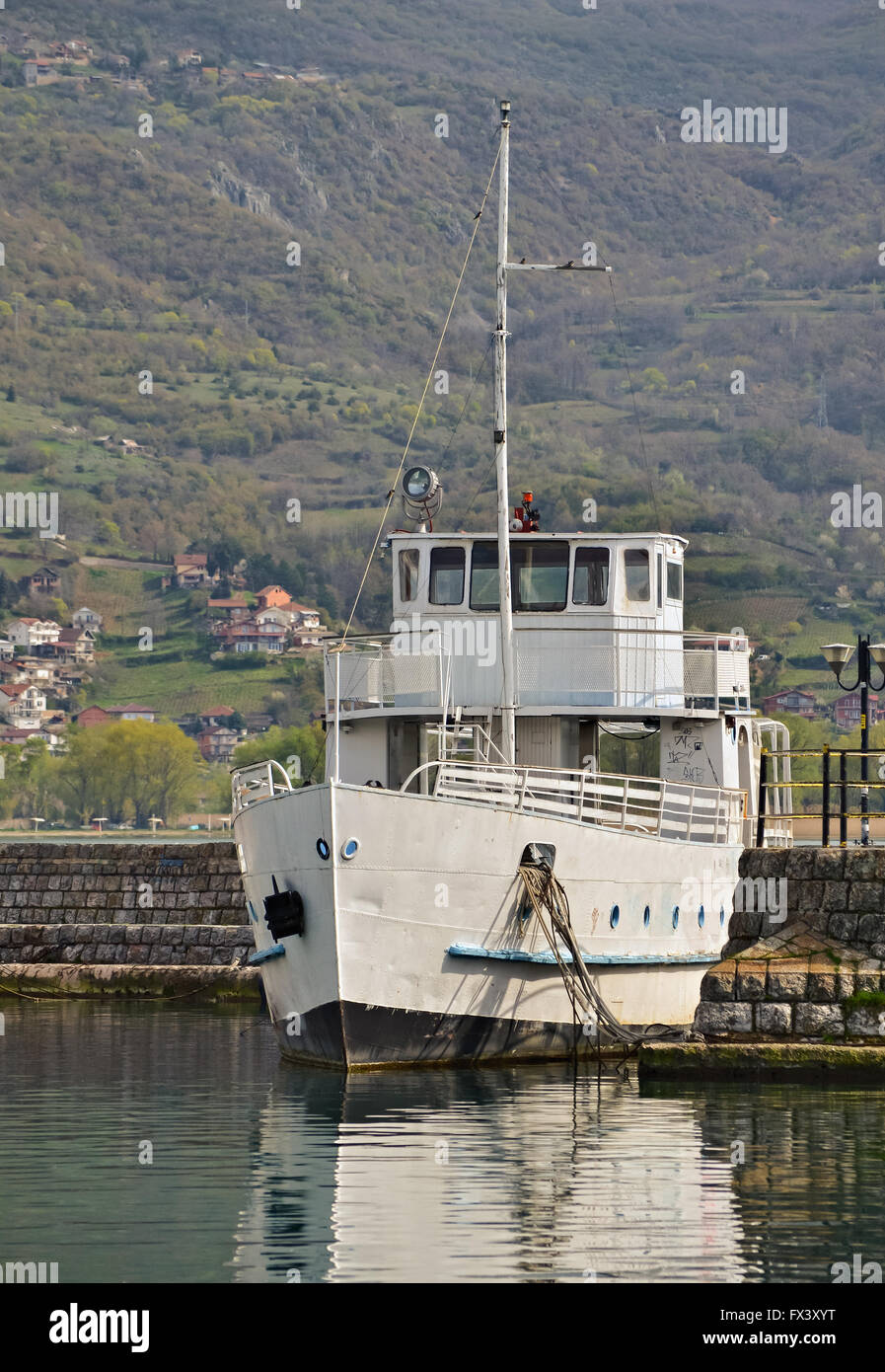 Un bateau blanc avec mât ancré à l'embarcadère du lac Banque D'Images