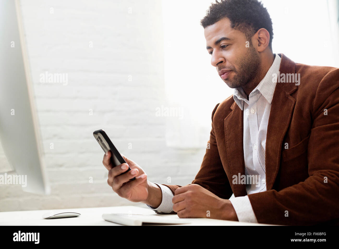 African American businessman using cell phone in office Banque D'Images