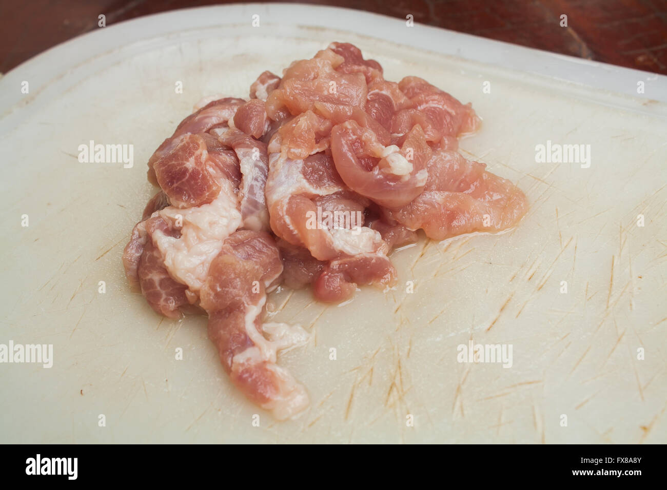 Tranches de porc sur le bloc de hachage en plastique Stock Photo Banque D'Images