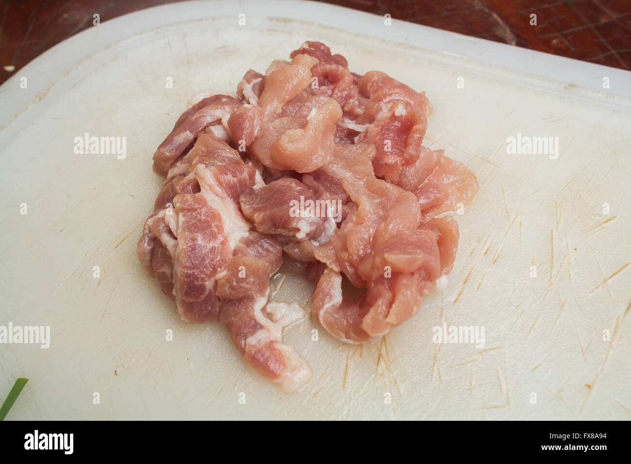 Tranches de porc sur le bloc de hachage en plastique Stock Photo Banque D'Images