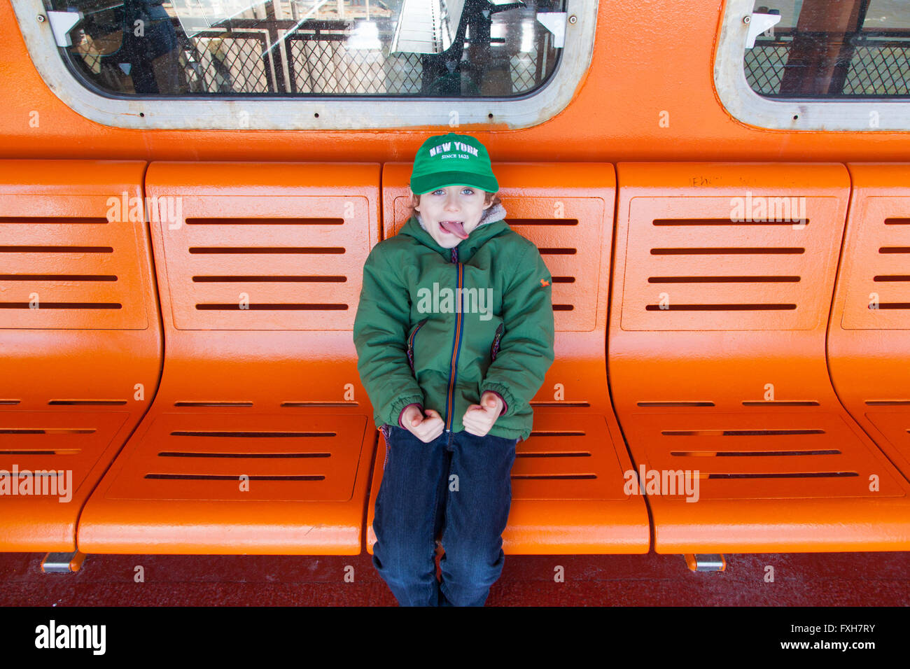 Un garçon de six ans sur le ferry pour Staten Island, New York City, États-Unis d'Amérique. Banque D'Images