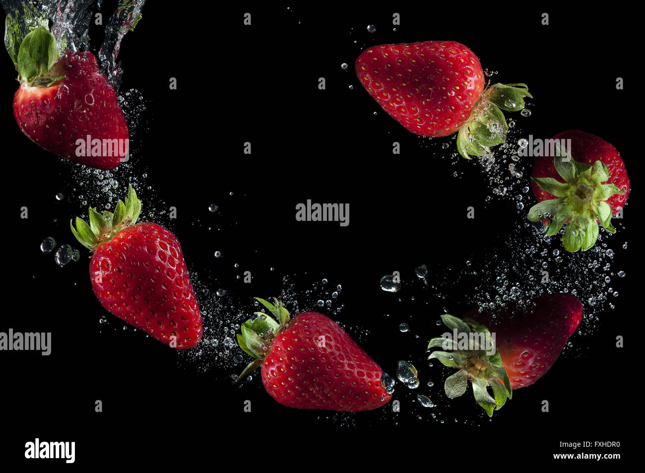 Les fraises dans l'eau plongée avec bulles Banque D'Images