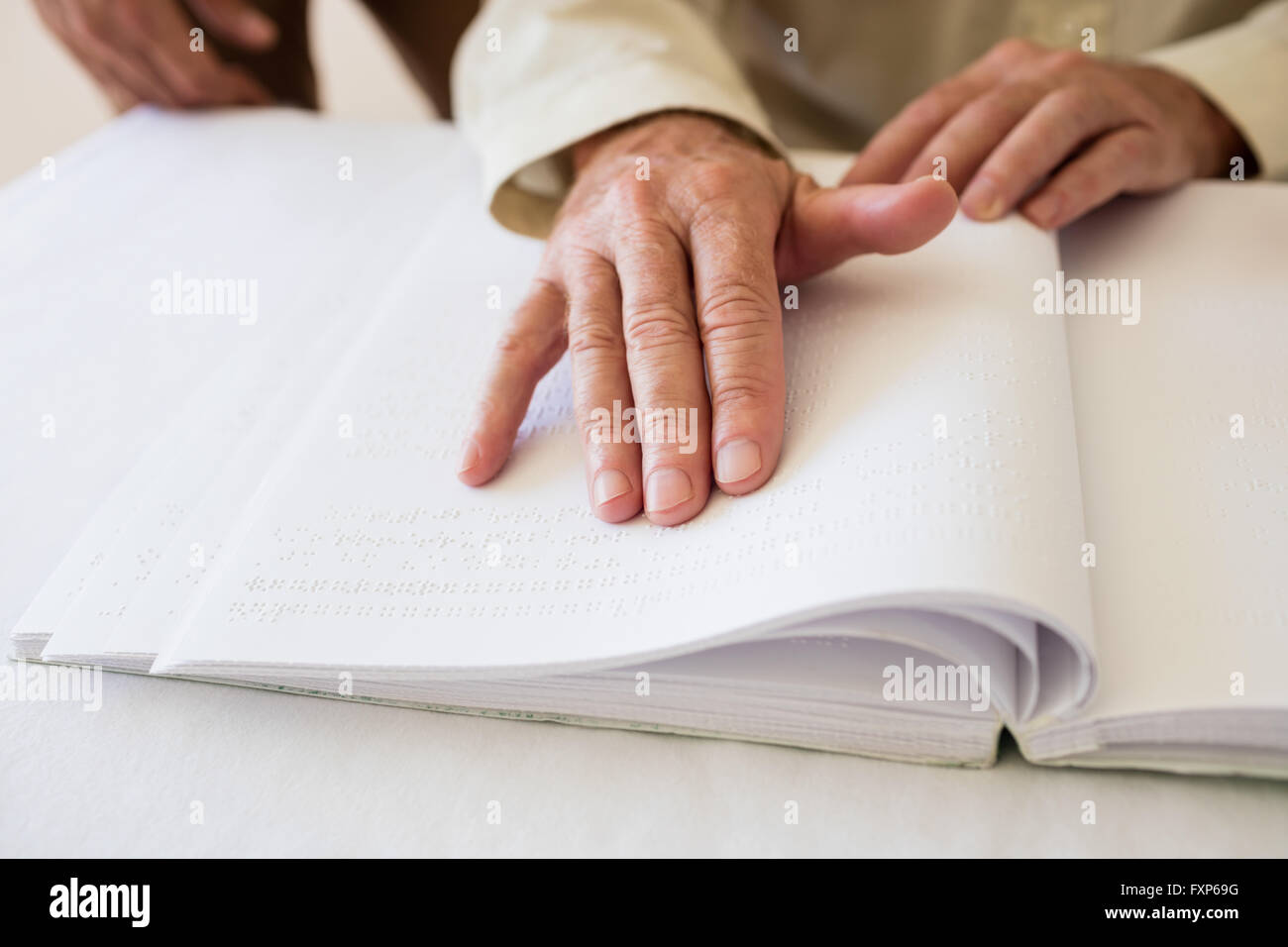Senior woman en utilisant le braille pour lire Banque D'Images