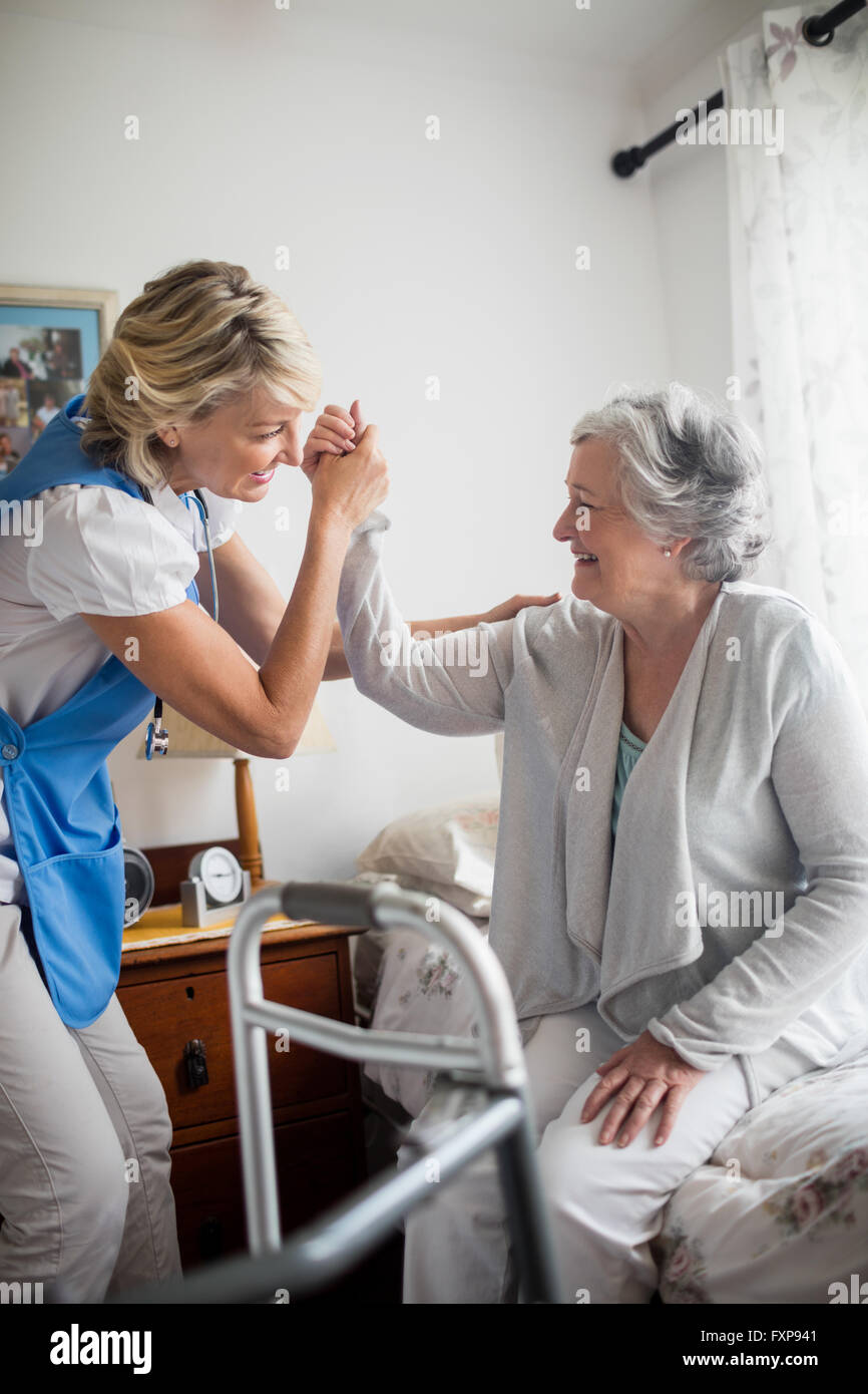 Nurse helping senior woman de se lever Banque D'Images