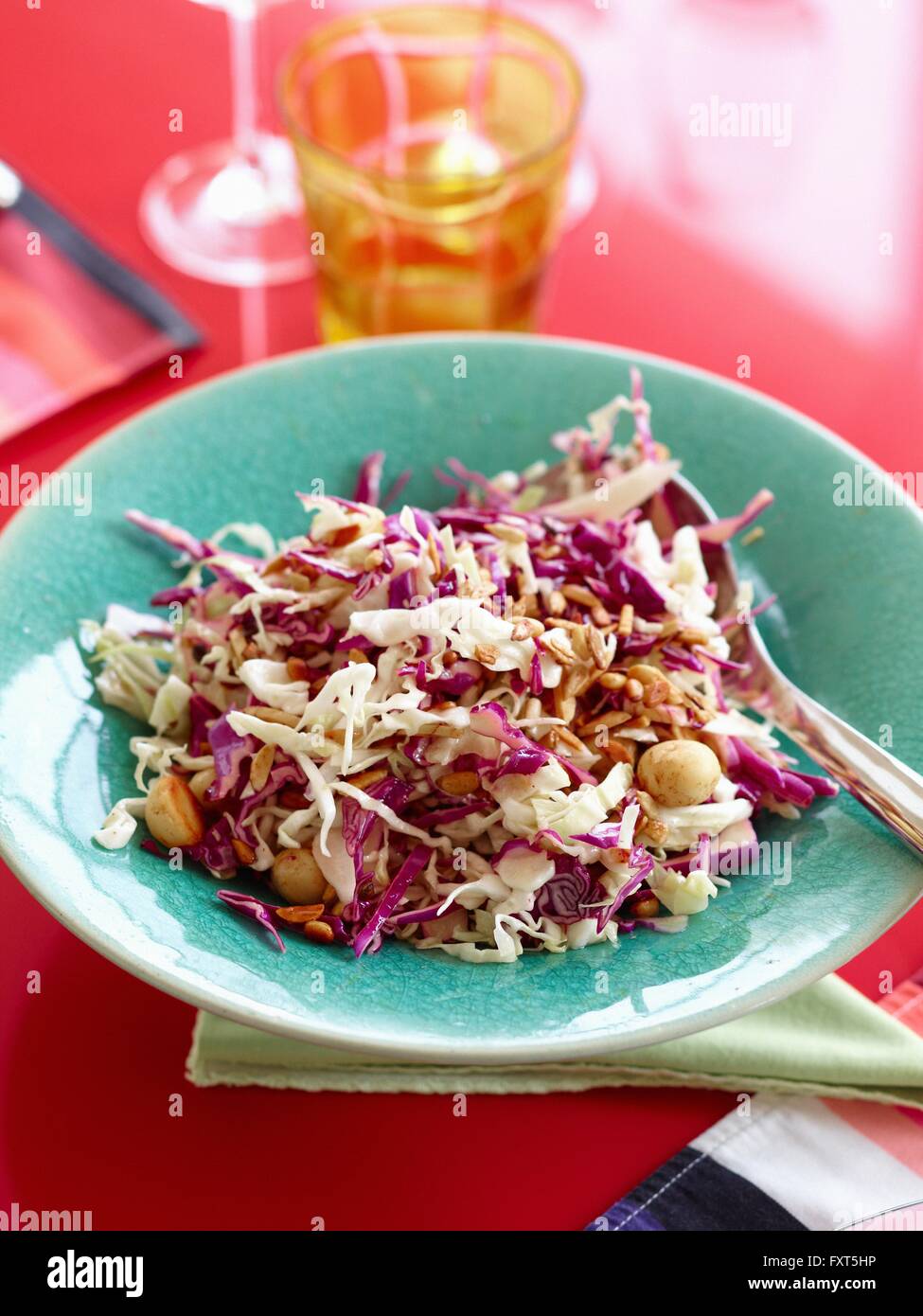 Portrait de salade de chou rouge et blanc avec les noix de macadamia dans bol bleu Banque D'Images