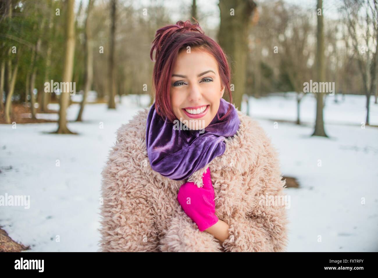 Portrait de jeune femme dans le parc couvert de neige, smiling Banque D'Images