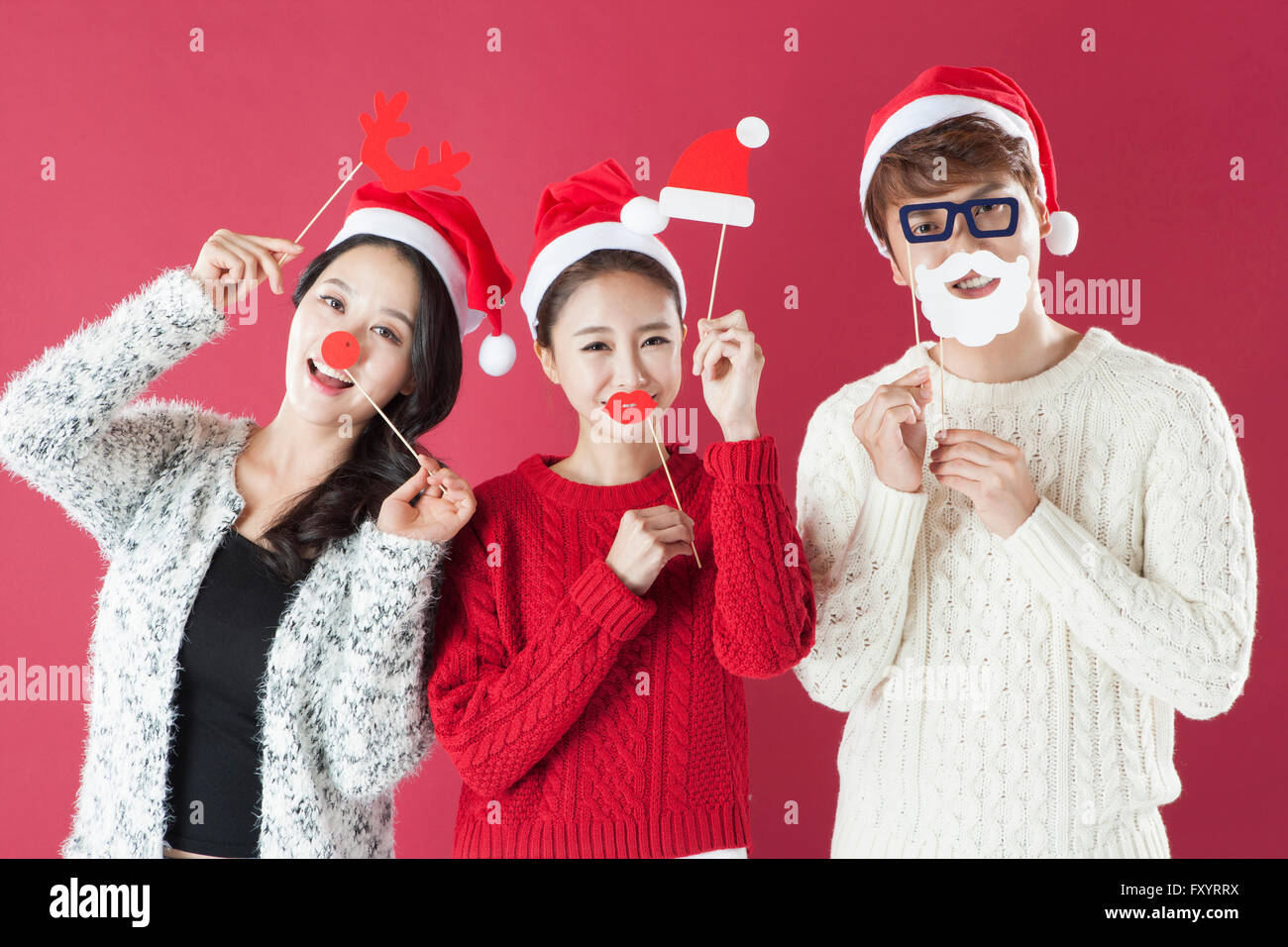 Portrait de trois jeunes gens souriants et cornes de cerf de nez, le chapeau et la barbe sata à regarder/ Banque D'Images