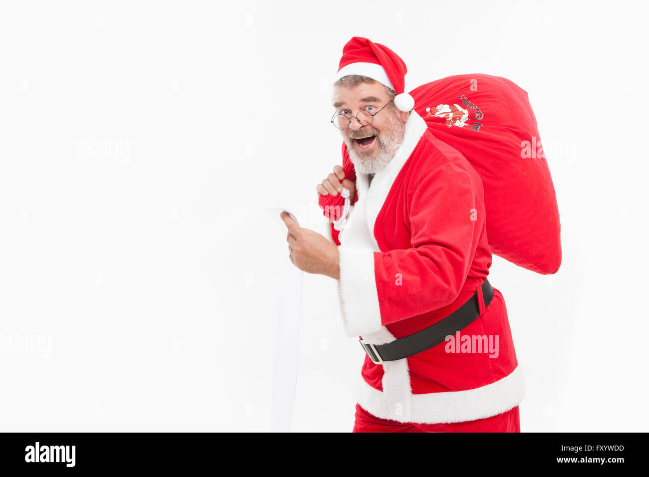Vue latérale du smiling Santa avec un sac à regarder/ Banque D'Images