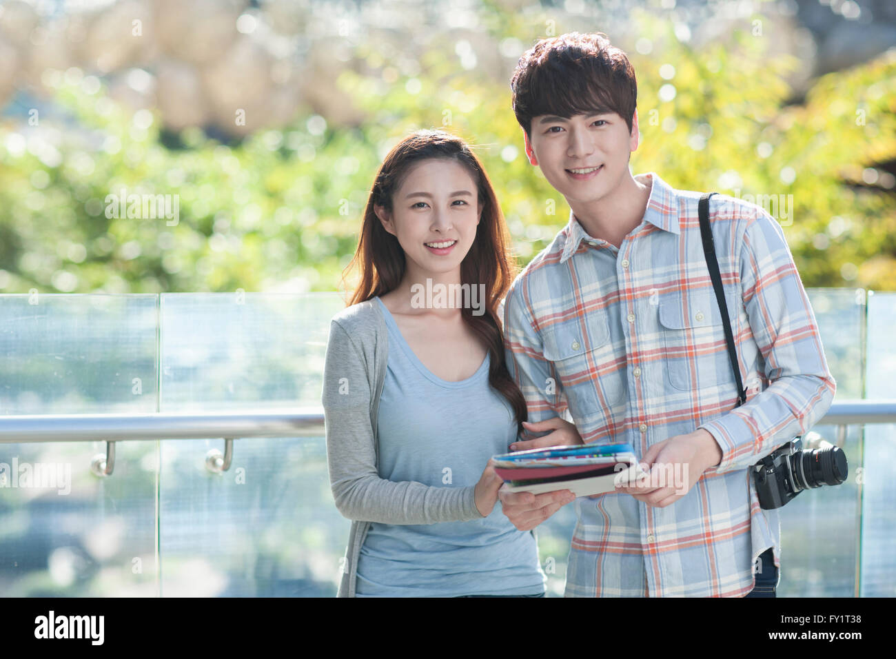 Portrait of young smiling couple ayant une date avec l'appareil photo et un guide Banque D'Images