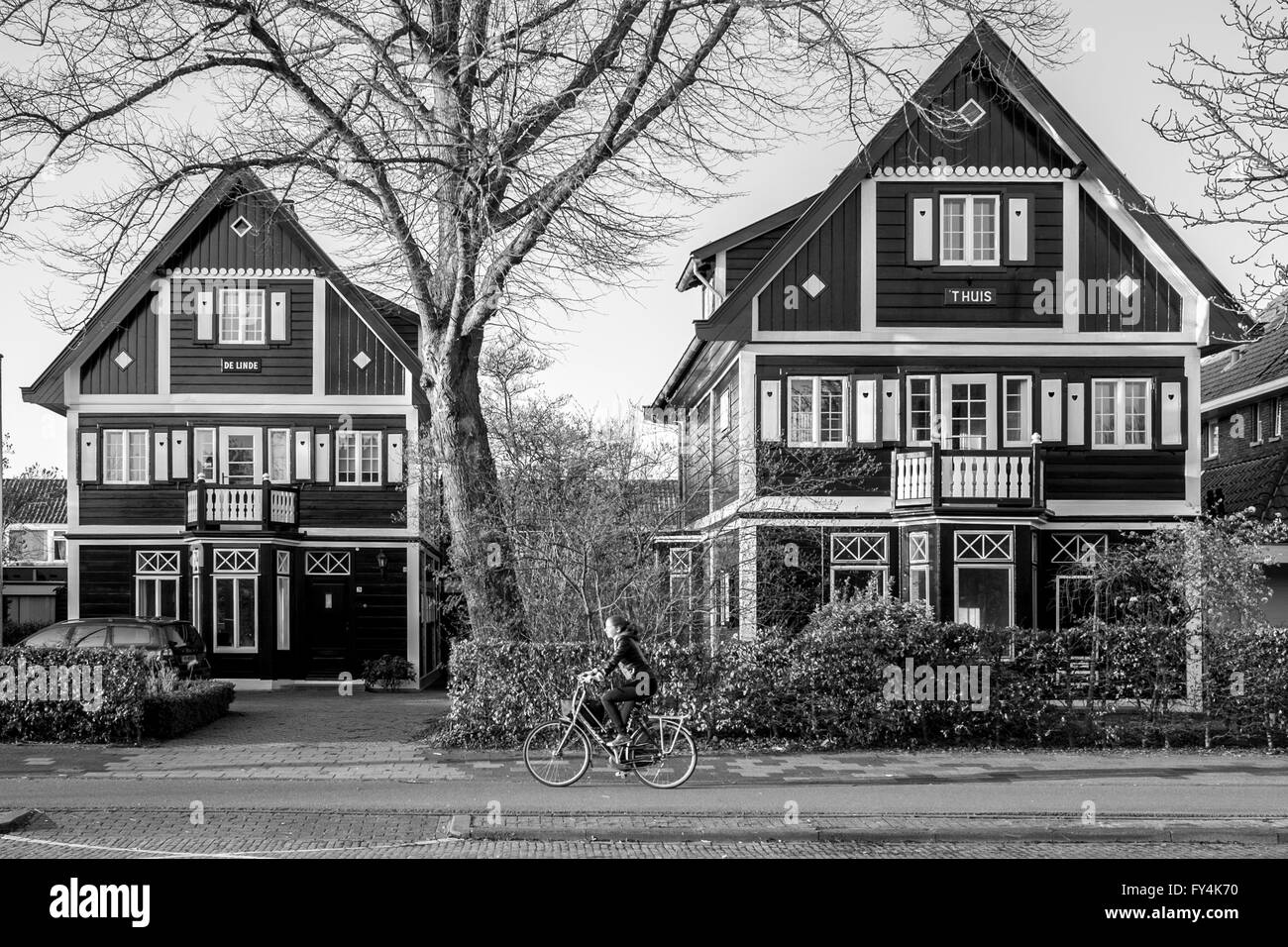 Une fille des vélos pour travailler l'école grâce à un quartier historique maison toit en pente à Leeuwarden, en Hollande, aux Pays-Bas. Banque D'Images