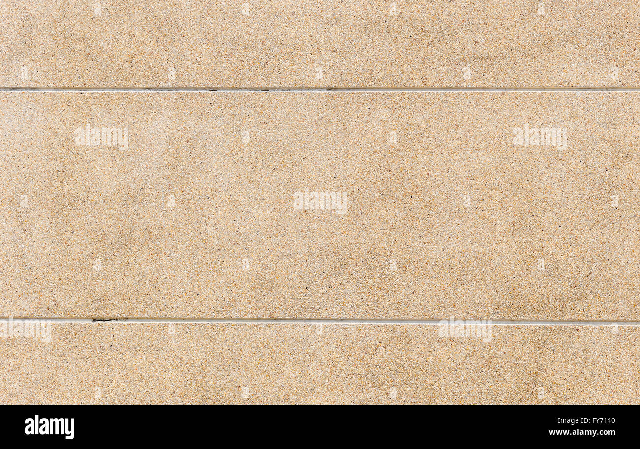 La texture rugueuse de la surface totale de la masse apparente, finition en pierre mur fait de petites pierres de sable mélangé Banque D'Images